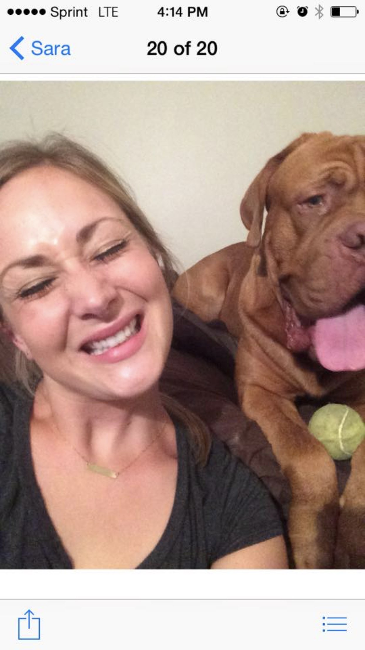 Sara taking a selfie with Augustus, her wrinkly mahogany Dogue de Bordeaux, his face filling the frame next to hers.