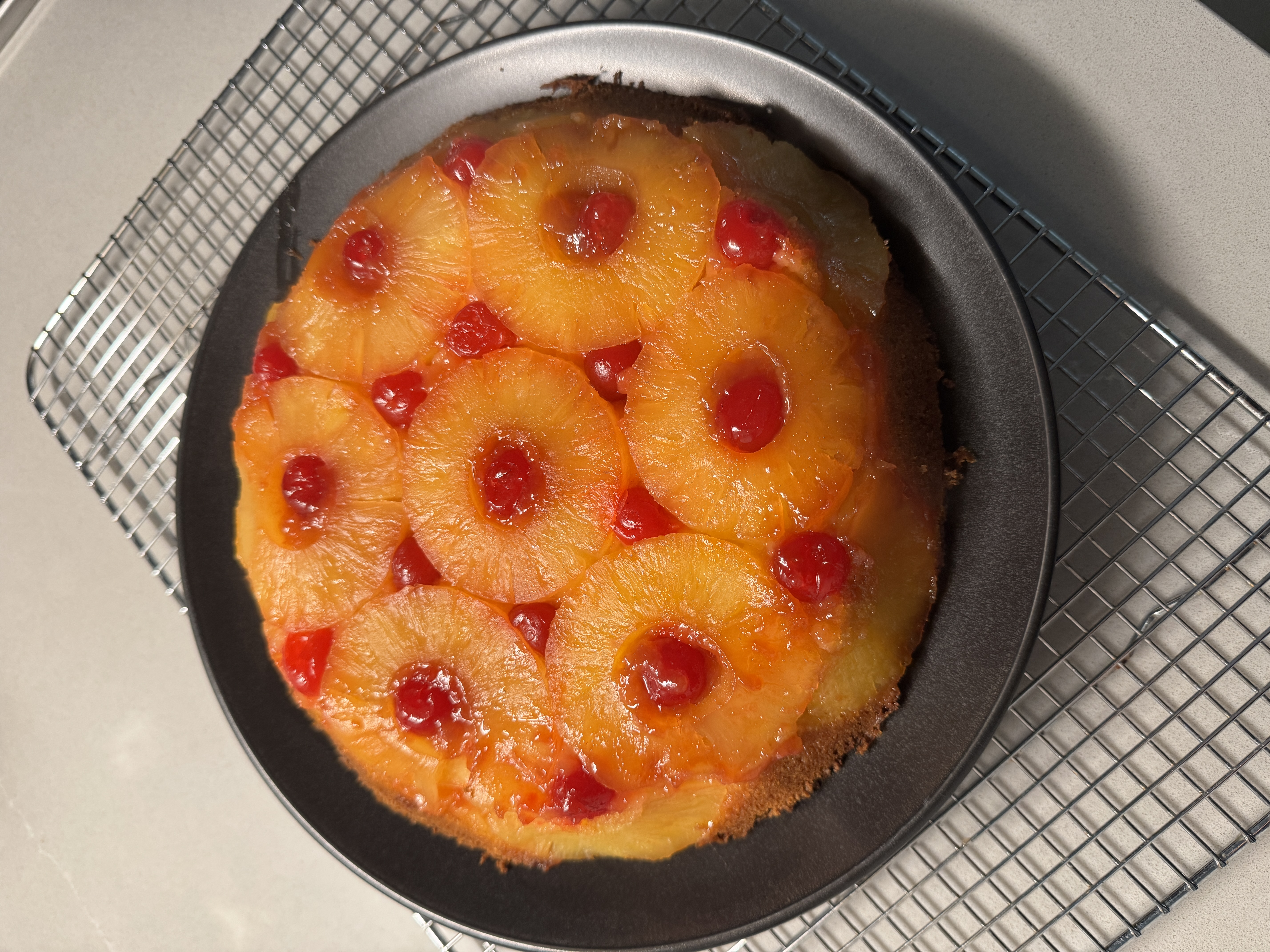 A pineapple upside-down cake with caramelized rings of pineapple across the top.
