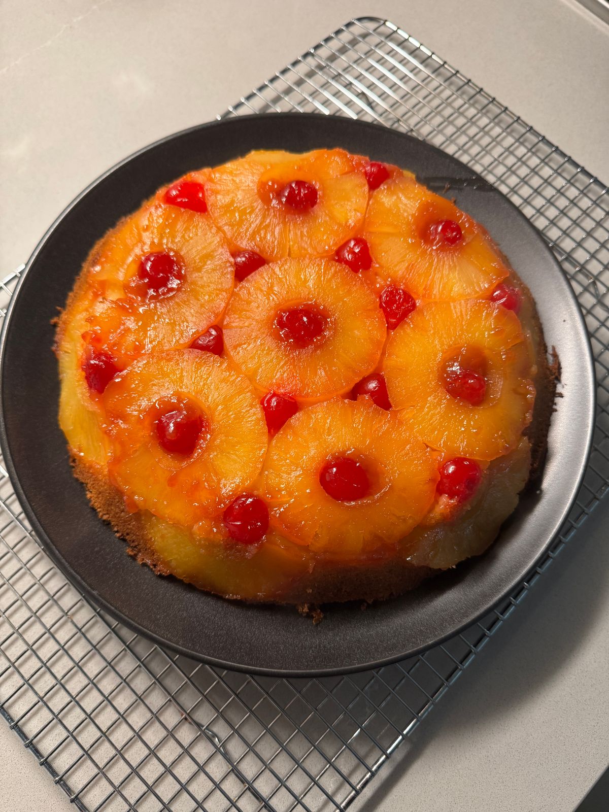 A pineapple upside-down cake with caramelized rings of pineapple across the top.