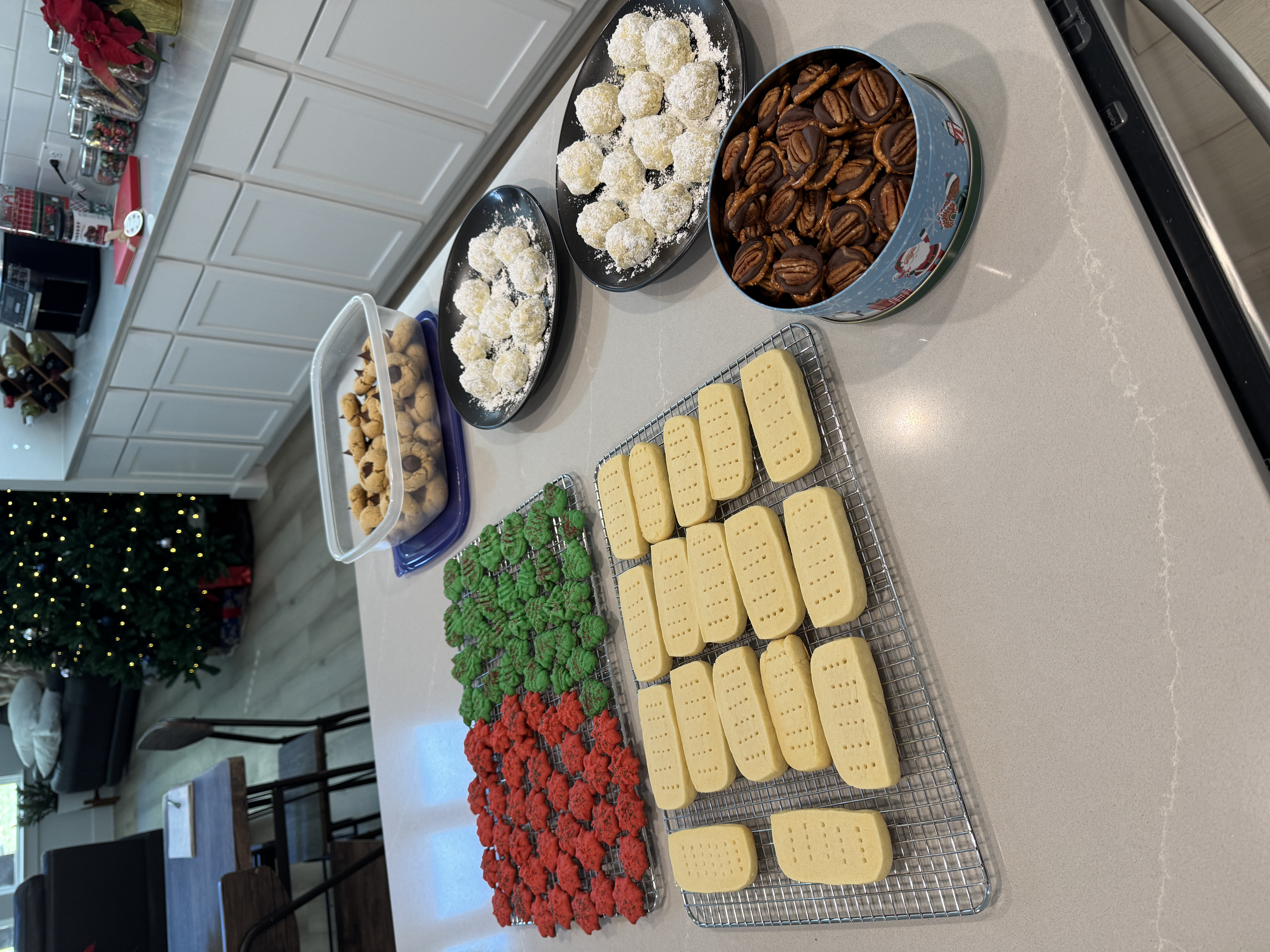 A holiday spread of coconut snowball truffles, candied pecans, Christmas cupcakes, and stamped shortbread.