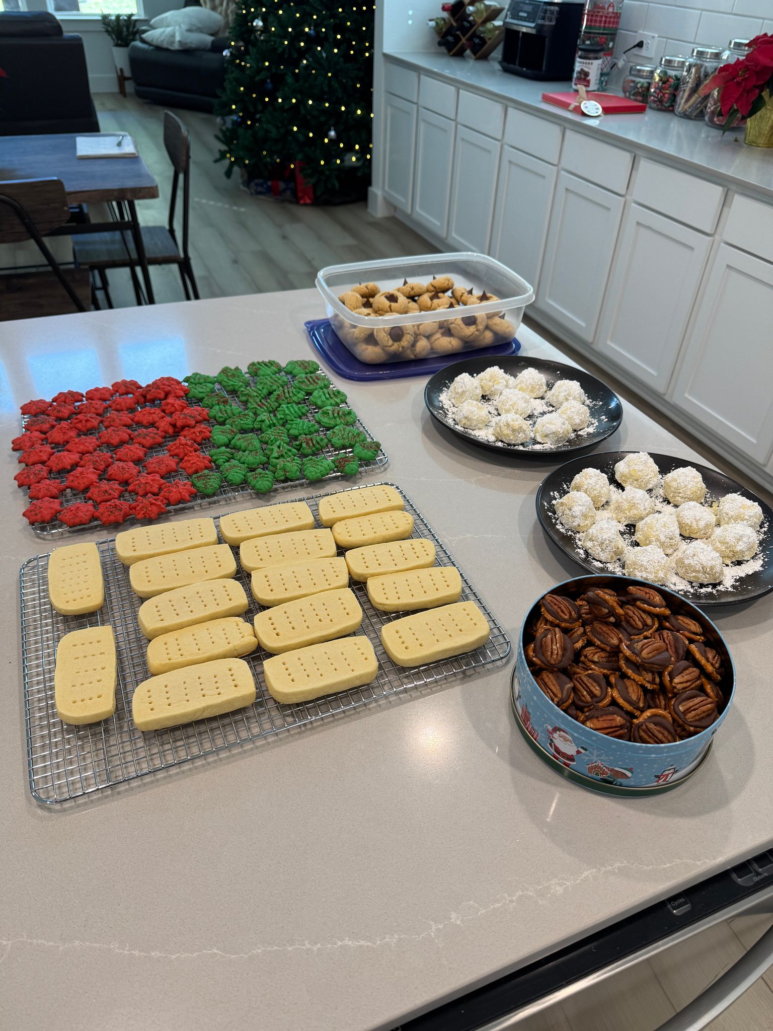 A holiday spread of coconut snowball truffles, candied pecans, Christmas cupcakes, and stamped shortbread.