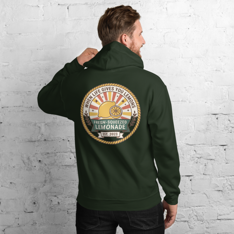 When Life Gives You Lemons hoodie — full-colour lemonade badge printed large across the back of a forest green hoodie